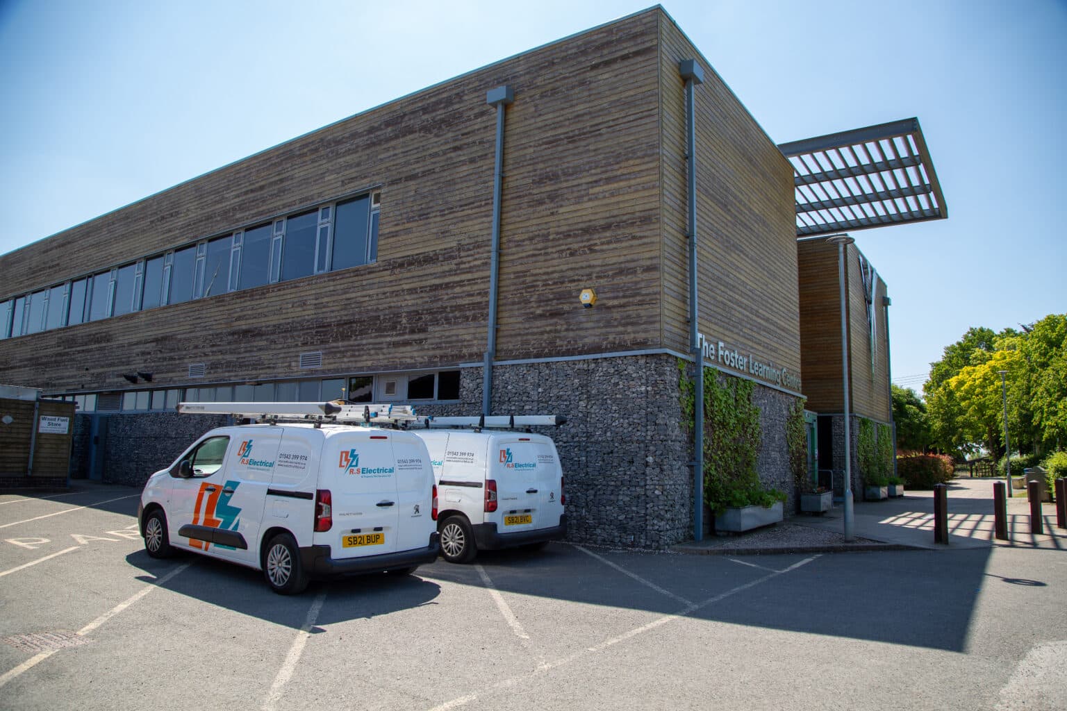 Exterior of The Foster Learning Centre at South Staffordshire College's Rodbaston Campus, with two liveried RS Electrical vans parked outside the building.